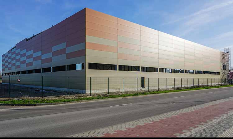 factory-building-security-fence Factory building with surrounding security fence