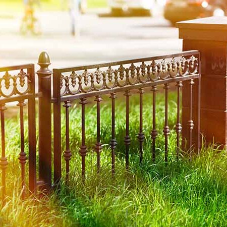 insert-wrought-iron-decor-fence Wrought iron fence with block columns